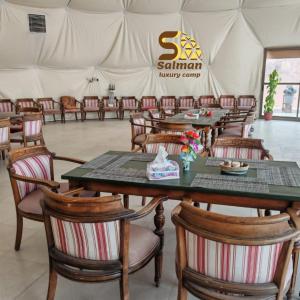 a marquee with tables and chairs in a tent at Wadi Rum Salman camp in Wadi Rum +10 photos