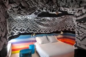 a bed in a room with a rainbow at Hotel The Exchange in Amsterdam