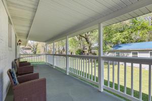 a covered porch with two chairs and a view of a yard at Country Charmer in Sevierville