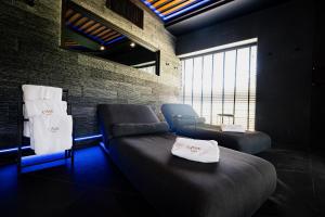 a room with a couch and a chair and a window at Cave Hotel & Golf Resort in Faversham