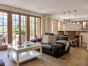 a living room with a couch and a table at Apartment Chalet Smaragd-1 by Interhome in Grindelwald