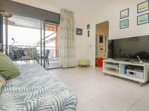 a bedroom with a bed and a tv in it at Apartment Tramuntana by Interhome in Lloret de Mar