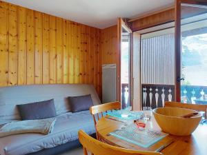 een woonkamer met een bank en een tafel bij Studio La pointe des Aravis 3 by Interhome in Saint-Gervais-les-Bains