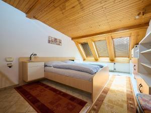 a bedroom with a bed and a wooden ceiling at Holiday Home Jesenný by Interhome in Jesenný