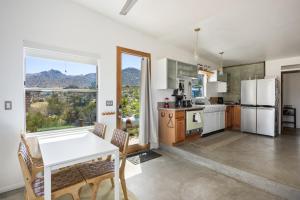 a kitchen with white appliances and a table with chairs at Jensen House - Incredible Desert Views home in Joshua Tree
