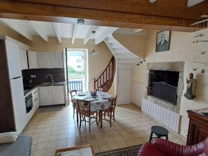 a kitchen and dining room with a table and chairs at Holiday Home Ty Tan-Nie by Interhome in Quiberon