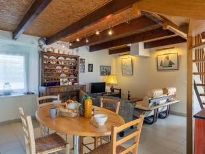 a kitchen and dining room with a table and chairs at Holiday Home Ty Croisic by Interhome in Penmarcʼh