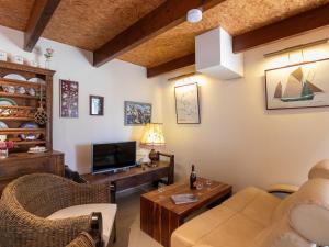 a living room with a couch and a tv at Holiday Home Ty Croisic by Interhome in Penmarcʼh