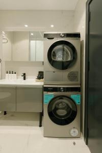 a kitchen with a washing machine and a sink at DeCamondo Residence Karaköy in Istanbul