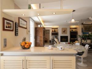 a kitchen and living room with a table and a dining room at Holiday Home Ty Pors Ar Pagn by Interhome in Penmarcʼh