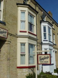 a brick building with a kirkbeck guest house sign in front of it at Kingsleigh Guest House in Lowestoft