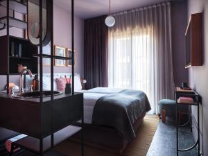 a bedroom with a bed and a sink and a window at lyf East Frankfurt in Frankfurt