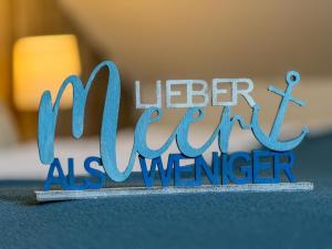 a blue sign that reads better ever as a teenager at Wenkendeck in Fehmarn