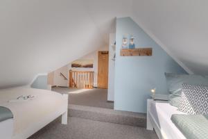 a living room with a staircase with a couch and a stair at Wenkendeck in Fehmarn