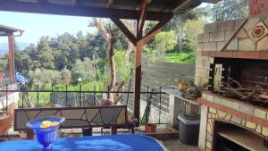 a patio with a table and a fireplace at Anatoli Kavala in Kavála