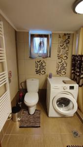 a bathroom with a toilet and a washing machine at Anatoli Kavala in Kavála +26 photos