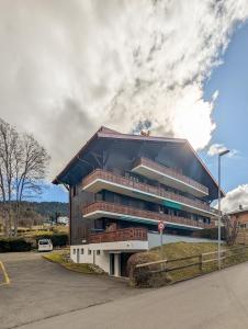 a large building with balconies on the side of a street at Rare, quite & centered Apartment with Garden & Fireplace in Villars-sur-Ollon