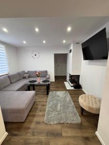 a living room with a couch and a table at Noclegi Leśne Bagno in Zwierzyniec