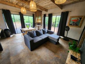 a living room with a couch and a table at Hartbeest Bush Stay #26 in Kosmos