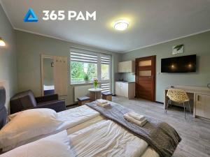 a bedroom with a large bed in a room at 365PAM - Studio C35 Dominikana in Sianozety