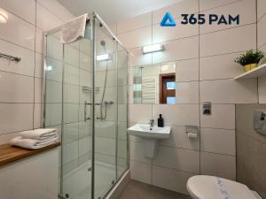 a bathroom with a glass shower and a sink at 365PAM - Studio C35 Dominikana in Sianozety +26 photos