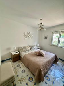 a bedroom with a bed and a chandelier at Capri Joy Apartments in Capri +67 photos