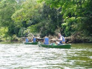 a group of people in canoes on a river at Green Jay Cabins in Duffy Bank