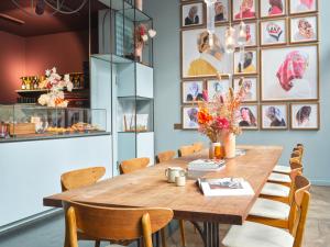 a dining room with a wooden table and chairs at lyf East Frankfurt in Frankfurt