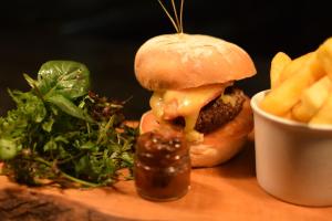 a cheeseburger and french fries on a wooden table at The Dolphin Inn in Thorpeness