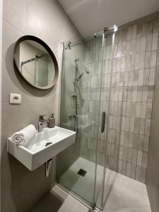 a bathroom with a shower and a sink and a mirror at New studio centre in Brussels