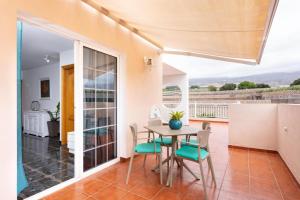 a dining room with a table and chairs at Ático San Juan Teide View in Playa de San Juan