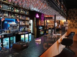 a bar with a counter and shelves of alcohol at Casa Bella Vista in Alhama de Murcia