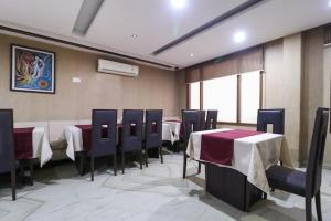 Un comedor con mesas y sillas en una habitación. en Hotel Himgiri, en Sohāna 1 foto más