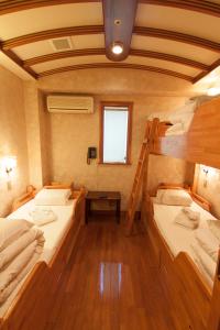 a room with two bunk beds in a boat at Capsule Inn Osaka (Male Only) in Osaka +62 photos