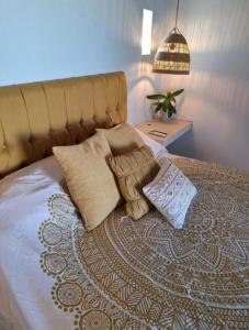 a bed with pillows on it in a bedroom at Casa Bonita in El Pescadero +6 photos