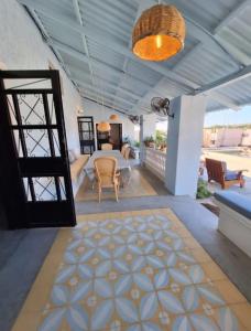 a room with a table and chairs and a door at Casa Bonita in El Pescadero