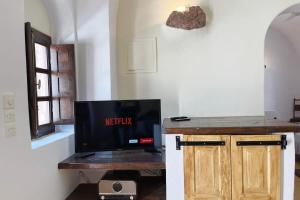 a tv sitting on a table in a room at The Commander's House in Emporio Santorini