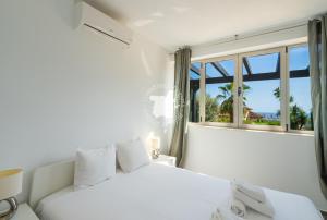 a white bedroom with two beds and a window at CostaBlancaDreams Casa con Vista in Calpe in Empedrola +47 photos