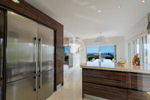 a kitchen with a stainless steel refrigerator and a counter at CostaBlancaDreams Casa con Vista in Calpe in Empedrola