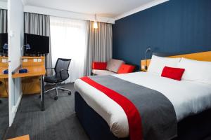 a hotel room with a large bed and a desk at Holiday Inn Express Derby Pride Park by IHG in Derby +38 photos