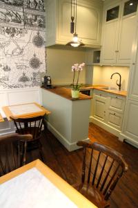 a kitchen with white cabinets and a table and chairs at L'Epicentre in Brussels +9 photos