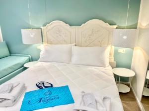 Postel nebo postele na pokoji v ubytování Hotel Astigiana & Appartamenti