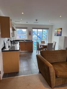 a kitchen and living room with a couch and a table at Modern, sleeps 6, rural market town, Llani in Llanidloes