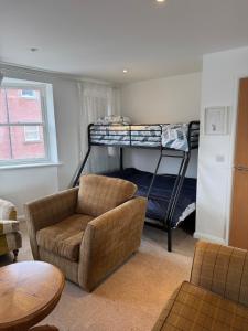 a living room with a couch and bunk beds at Modern, sleeps 6, rural market town, Llani in Llanidloes