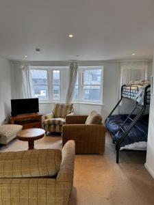 a living room with a couch and a bunk bed at Modern, sleeps 6, rural market town, Llani in Llanidloes +18 photos