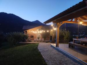 a house with a patio at night with lights at Cabana Livada in Borşa