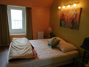 a bedroom with a bed with two pillows on it at Charmante petite maison proche de Meymac in Meymac