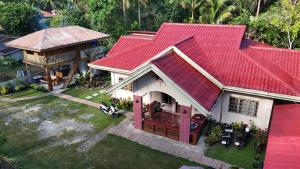 an overhead view of a house with a red roof at Khloe Serenity Guest House in Batuan