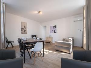 una sala da pranzo con tavolo, sedie e divano di Apartment Malecot I by Interhome a Blankenberge