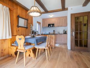 a kitchen with a table and chairs in a room at Chalet Le Katanga by Interhome in Ovronnaz +31 photos